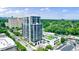 Stunning aerial view of luxury condo building with rooftop terrace, swimming pool, and city skyline at 2425 Peachtree Rd # 1806, Atlanta, GA 30305