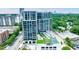Stunning aerial view of the modern high-rise with a pool, tennis court, and green spaces at 2425 Peachtree Rd # 1806, Atlanta, GA 30305