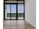 Bright bedroom with a wall of sliding glass doors leading to a balcony with lovely green views at 2425 Peachtree Rd # 1806, Atlanta, GA 30305