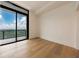 Bright bedroom with a wall of sliding glass doors leading to a balcony with lovely green views at 2425 Peachtree Rd # 1806, Atlanta, GA 30305