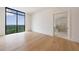 Sunlit bedroom boasts hardwood floors, a scenic view, and a modern ensuite bathroom at 2425 Peachtree Rd # 1806, Atlanta, GA 30305