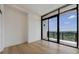 Bright bedroom with a wall of sliding glass doors leading to a balcony with lovely green views at 2425 Peachtree Rd # 1806, Atlanta, GA 30305