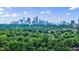 Breathtaking view of the city skyline overlooking lush green trees and blue skies with wispy clouds at 2425 Peachtree Rd # 1806, Atlanta, GA 30305