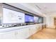 Entertainment area with multiple large screen televisions and kitchenette and seating area with modern finishes at 2425 Peachtree Rd # 1806, Atlanta, GA 30305