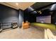 A modern entertainment room features theater-style seating and a golf simulator for recreation at 2425 Peachtree Rd # 1806, Atlanta, GA 30305