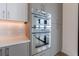 Modern kitchen features stainless steel appliances, gray cabinetry, and sleek countertops at 2425 Peachtree Rd # 1806, Atlanta, GA 30305