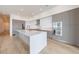 Bright modern kitchen with oversized island, stainless steel appliances, and wood flooring at 2425 Peachtree Rd # 1806, Atlanta, GA 30305