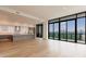 Open concept living area, blending kitchen and living room with large windows and city views at 2425 Peachtree Rd # 1806, Atlanta, GA 30305