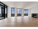 Open living area featuring hardwood floors, fireplace, and expansive windows with scenic views at 2425 Peachtree Rd # 1806, Atlanta, GA 30305