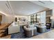 Open-concept living room with plush seating, stylish decor, and views of the community outdoor space at 2425 Peachtree Rd # 1806, Atlanta, GA 30305