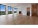 Spacious living room with hardwood floors, fireplace, and large windows offering scenic views at 2425 Peachtree Rd # 1806, Atlanta, GA 30305