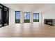 Bright living area featuring hardwood floors, fireplace, and expansive windows with scenic views at 2425 Peachtree Rd # 1806, Atlanta, GA 30305