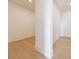 Neutral living space with light hardwood flooring, white walls, and a corner column feature at 2425 Peachtree Rd # 1806, Atlanta, GA 30305