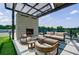 Outdoor patio with fireplace, couches, and comfortable seating at 2425 Peachtree Rd # 1806, Atlanta, GA 30305