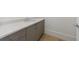Elegant powder room featuring sleek cabinets, modern hardware, light countertops and hardwood floors at 2425 Peachtree Rd # 1806, Atlanta, GA 30305