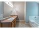 Bright bathroom with soaking tub, updated vanity and spacious countertops at 260 Redding Rdg, Atlanta, GA 30349