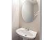 A cozy powder room featuring a pedestal sink and an oval mirror at 260 Redding Rdg, Atlanta, GA 30349