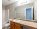 A well lit bathroom with a wide mirror, neutral walls, and functional features at 260 Redding Rdg, Atlanta, GA 30349