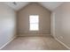 This carpeted bedroom has neutral paint and a vaulted ceiling. A window provides plenty of natural light at 260 Redding Rdg, Atlanta, GA 30349