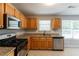 Modern kitchen featuring granite countertops, stainless steel appliances, and natural wood cabinetry at 260 Redding Rdg, Atlanta, GA 30349