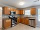 Contemporary kitchen with stainless steel appliances, granite counters, and abundant cabinet storage at 260 Redding Rdg, Atlanta, GA 30349