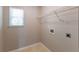 Bright laundry room equipped with a window, shelving, and utility connections at 260 Redding Rdg, Atlanta, GA 30349