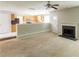 Open-concept living room with fireplace, ceiling fan, and view of the kitchen at 260 Redding Rdg, Atlanta, GA 30349