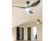 Attic with two modern black ceiling fans, three doorways and wood-look floors has unique architectural design at 300 Saddle Creek Ln, Roswell, GA 30076