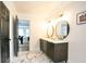 Bathroom with double vanity, marble flooring, and view into the Primary bedroom at 300 Saddle Creek Ln, Roswell, GA 30076