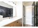 Bathroom with vanity, black accents, and a view into the shower/bath area at 300 Saddle Creek Ln, Roswell, GA 30076