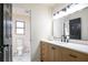 Bathroom with black accents, wood vanity, and view into another room at 300 Saddle Creek Ln, Roswell, GA 30076