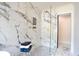Close up of a luxurious shower with marble tile, accent tile, and glass enclosure at 300 Saddle Creek Ln, Roswell, GA 30076