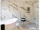 Close up of a luxurious bathroom with marble tile, a soaking tub, and a glass-enclosed shower at 300 Saddle Creek Ln, Roswell, GA 30076