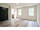 Bedroom with hardwood floors, two windows, and a view into the bathroom at 300 Saddle Creek Ln, Roswell, GA 30076