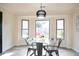 Dining room features a glass table, dark metal chairs and a bay window allowing for natural light at 300 Saddle Creek Ln, Roswell, GA 30076
