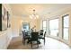 Elegant dining room featuring a bay window, modern lighting fixture, and wood floors at 300 Saddle Creek Ln, Roswell, GA 30076
