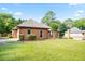 Beautiful brick house featuring a lush green lawn and mature trees in a suburban setting at 300 Saddle Creek Ln, Roswell, GA 30076