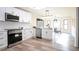 Updated white kitchen features stainless steel appliances, marble countertops, and an adjoining dining area at 300 Saddle Creek Ln, Roswell, GA 30076