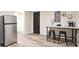 Kitchen area featuring stainless steel refrigerator and breakfast bar seating at 300 Saddle Creek Ln, Roswell, GA 30076