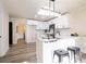 Updated white kitchen includes bar with marble countertops and modern black fixtures and stainless steel appliances at 300 Saddle Creek Ln, Roswell, GA 30076