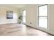 Bright living room featuring new wood floors, two windows, and neutral paint at 300 Saddle Creek Ln, Roswell, GA 30076