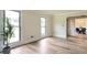 Bright living room featuring new wood floors, two windows, neutral paint, and an open doorway at 300 Saddle Creek Ln, Roswell, GA 30076