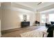 Bright main bedroom with tray ceiling, new wood floors, and neutral paint at 300 Saddle Creek Ln, Roswell, GA 30076