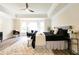 Bright main bedroom with tray ceiling, new wood floors, and a seating area by the large bay windows at 300 Saddle Creek Ln, Roswell, GA 30076