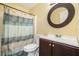 A bathroom features a shower and vanity with a round mirror at 4077 High Country Dr, Douglasville, GA 30135