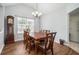 Traditional dining room featuring wood floors, classic furniture, and natural light through a large window at 4077 High Country Dr, Douglasville, GA 30135