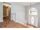 Bright foyer with wood floors, white banister, and decorative front door with complementing arched window above at 4077 High Country Dr, Douglasville, GA 30135