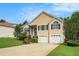 Charming two-story home featuring manicured lawn, two car garage, and classic front door with arched window at 4077 High Country Dr, Douglasville, GA 30135