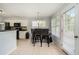 Bright eat-in kitchen with white cabinets, dark countertops, tile floors, and breakfast bar with modern lighting at 4077 High Country Dr, Douglasville, GA 30135