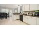 Bright eat-in kitchen with white cabinets, dark countertops, tile floors, and modern black appliances at 4077 High Country Dr, Douglasville, GA 30135